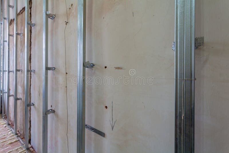 Interior of apartment with materials during on the renovation and construction. Making wall from drywall stock photography