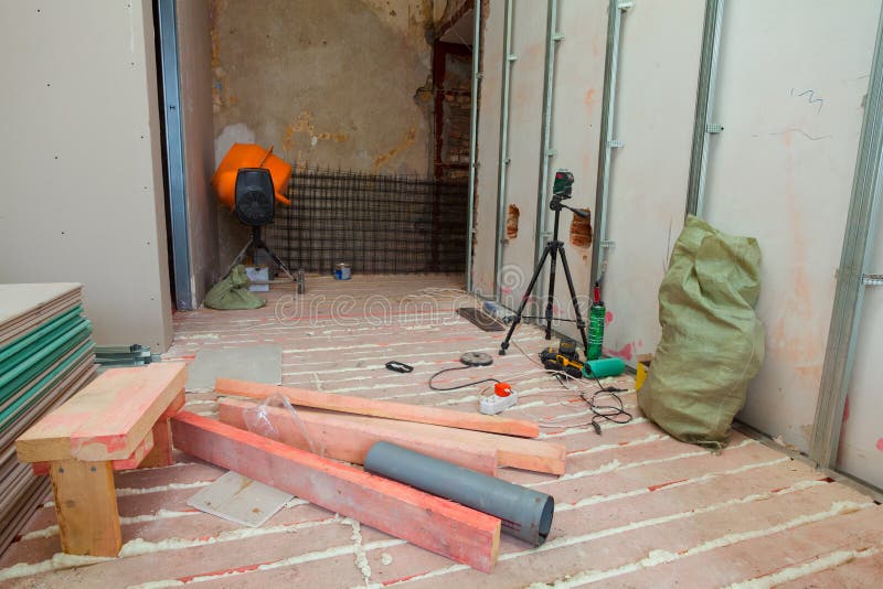 Interior of apartment with materials during on the renovation and construction. Making wall from drywall royalty free stock photo