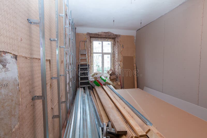 Interior of apartment with materials during on the renovation and construction. Remodel wall from gypsum plasterboard royalty free stock images