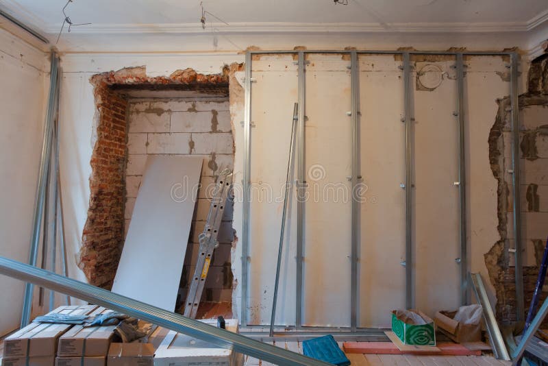 Interior of apartment with materials during on the renovation and construction. Remodel wall from gypsum plasterboard stock image