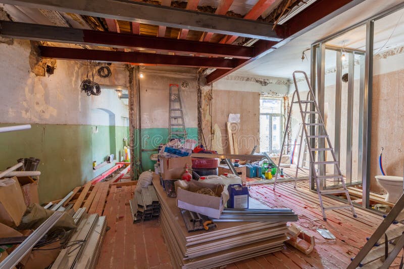 Interior of apartment with materials during on the renovation and construction. Remodel wall from gypsum plasterboard or drywall stock image