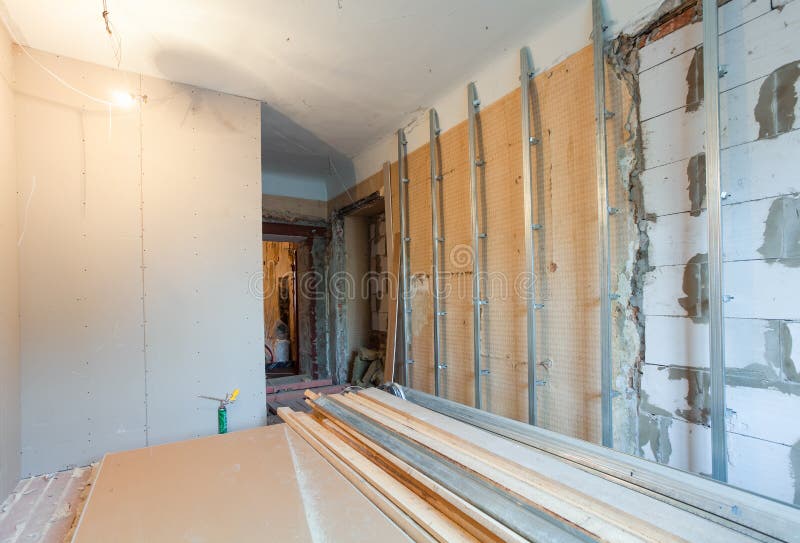 Interior of apartment with materials during on the renovation making wall from gypsum plasterboard. Interior of apartment with materials during on the renovation stock image