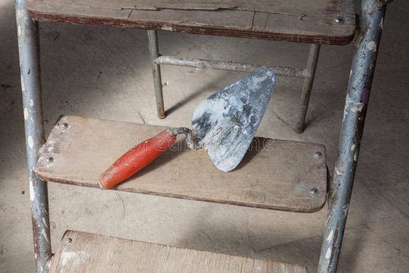 Interior of apartment during under renovation, remodeling and construction a putty knife on the ladder. royalty free stock photo