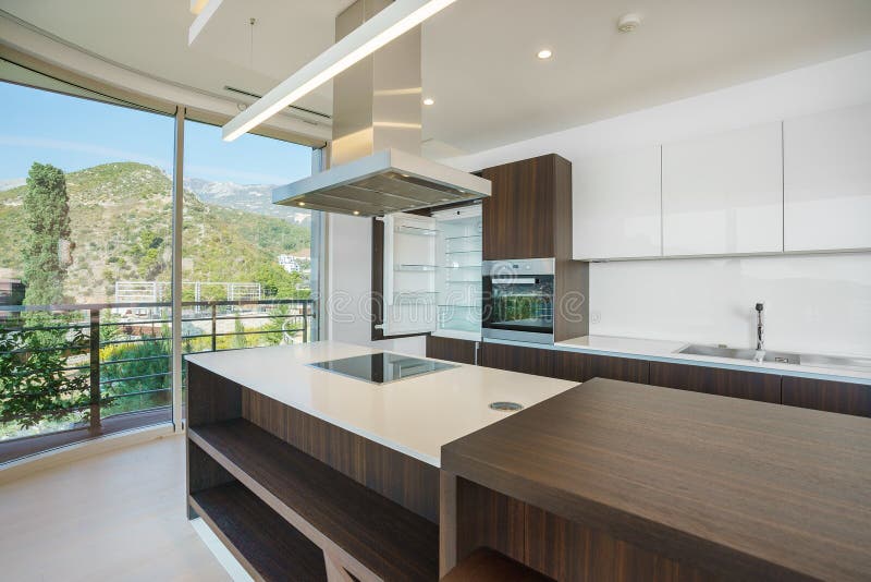 Interior of light spacious kitchen. With large panoramic windows in a luxury villa royalty free stock photo