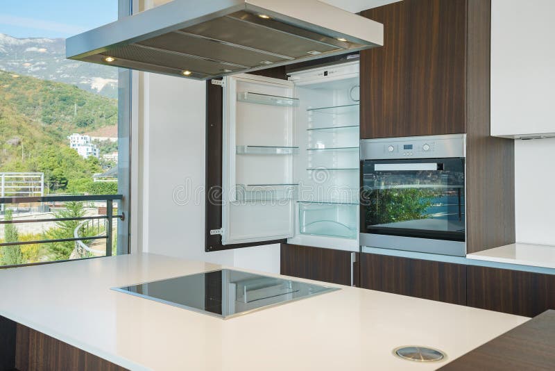 Interior of light spacious kitchen. With large panoramic windows in a luxury villa royalty free stock photo