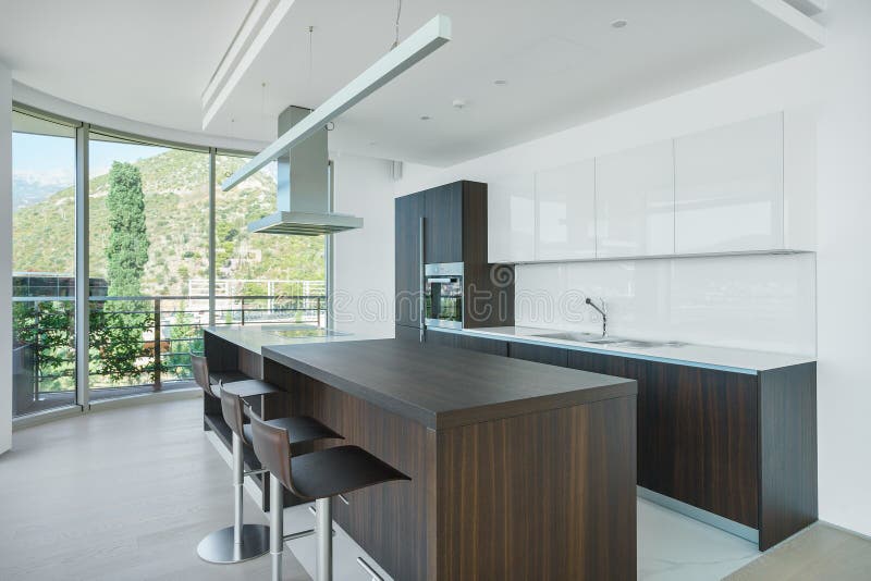 Interior of light spacious kitchen. With large panoramic windows in a luxury villa stock photos