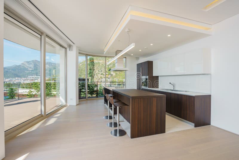 Interior of light spacious kitchen. With large panoramic windows in a luxury villa stock photography