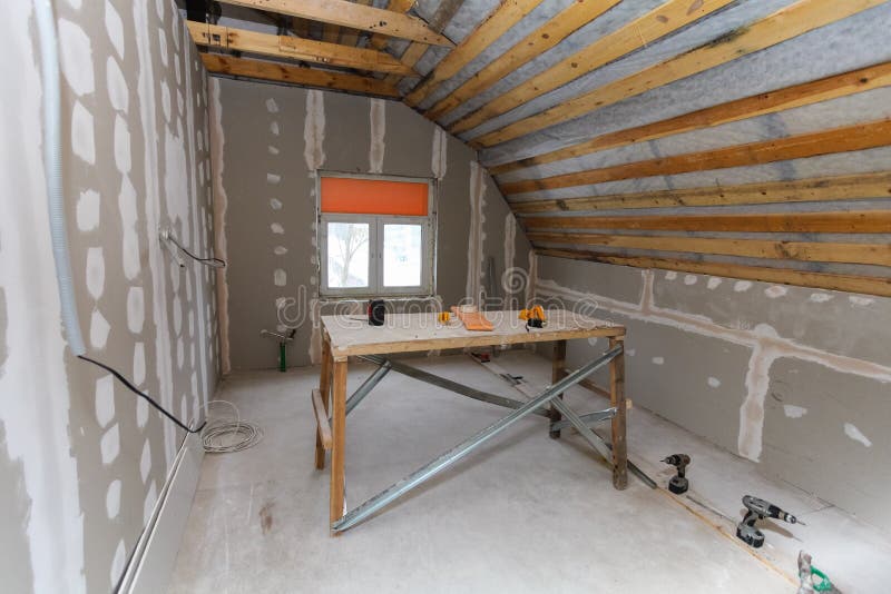 Interior of room apartment with new window and materials home-made scaffold, drills, level during on the renovation. Overhaul and construction remodeling and royalty free stock photography