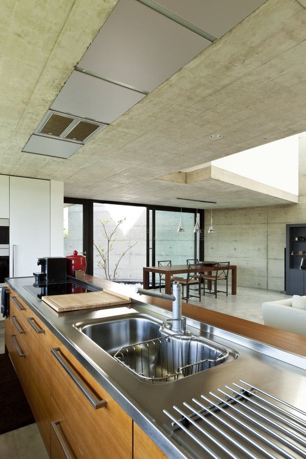 Interior, wooden kitchen island. Beautiful modern house in cement, interior, wooden kitchen island royalty free stock photo