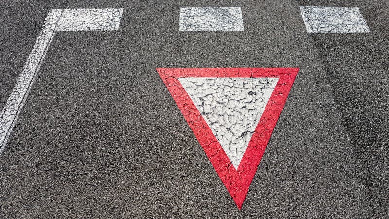 Inverted white with red border triangular road sign yield that you need to wait royalty free stock photography