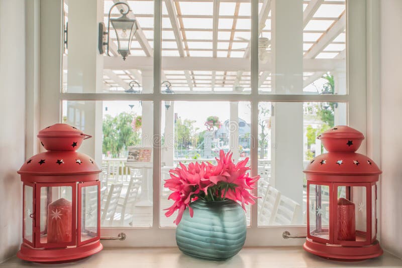 Jug of fresh summer flowers and lamps on a window sill stock photography