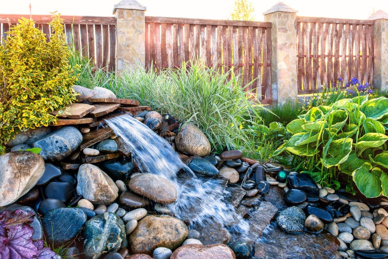 Landscape design, Alpine slide with a large fountain and a stream stock images