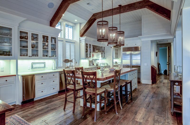 Large expensive chefs kitchen in luxury home with rough hewn wood and white cabinets.  royalty free stock photos