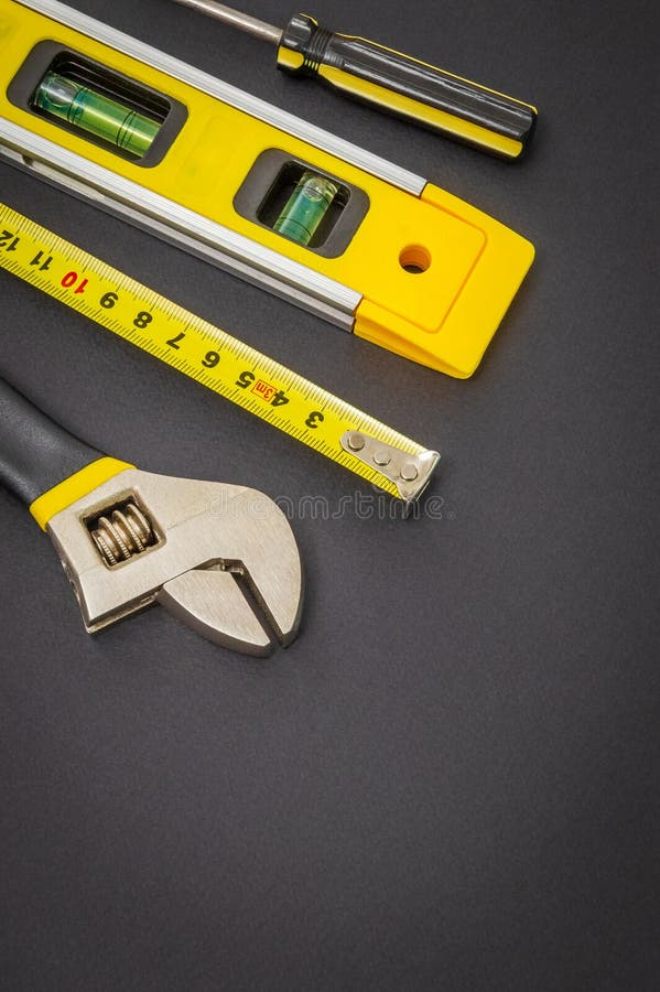 Large set of tools on black background prepared by the master before repair or construction stock images