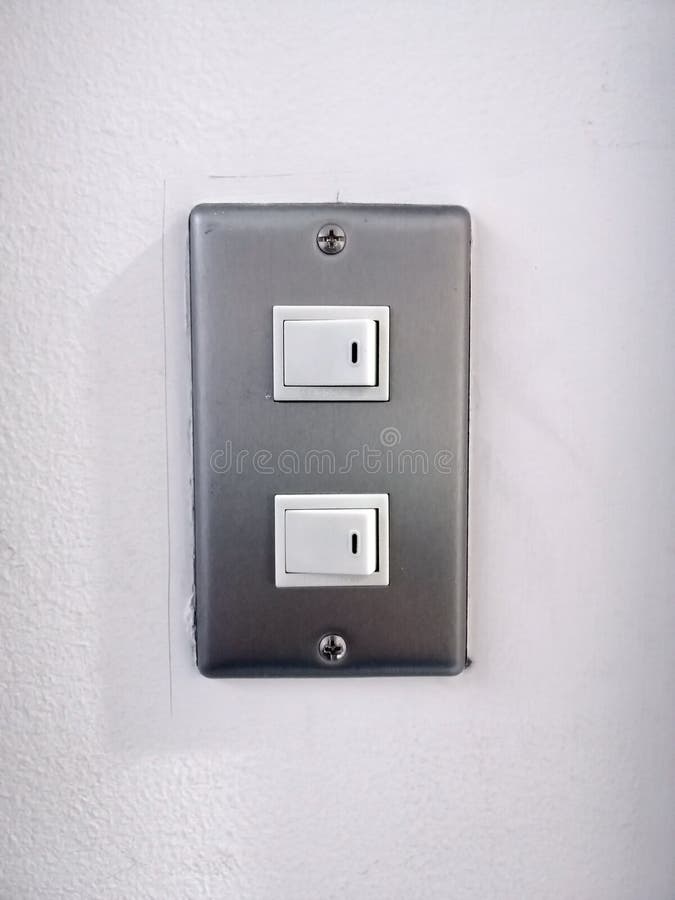 Light switch on wall. Electrical switch, power switch. A light switch is a switch most commonly used to operate electric lights, permanently connected equipment stock image