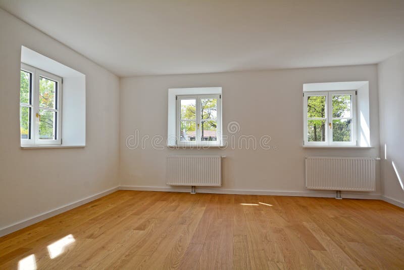Living room in an old building - Apartment with wooden windows and parquet flooring after renovation. Living room in an old building - Empty Apartment with stock photography