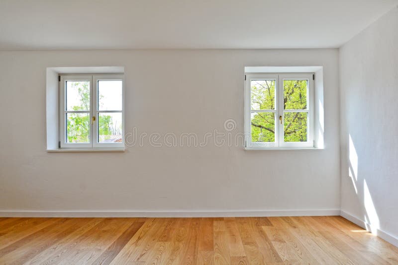 Living room in an old building - Apartment with wooden windows and parquet flooring after renovation. Living room in an old building - Empty Apartment with stock photos