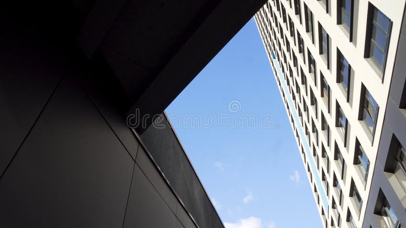 Looking up at a group of modern office buildings on blue sky background. Frame. Glass city buildings during sunny day stock photos