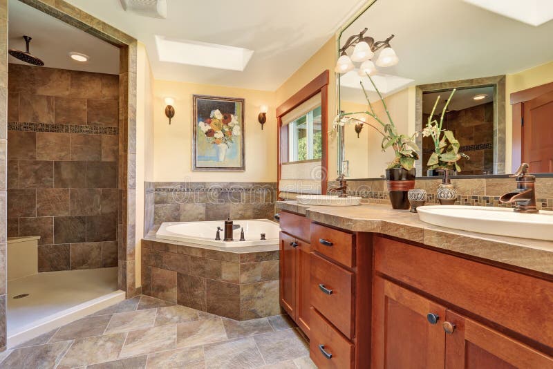 Lovely master bathroom with stone floor and large shower. stock photography