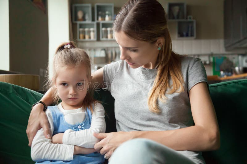 Loving mother consoling insulted upset stubborn kid daughter avo. Loving mother consoling or trying make peace with insulted upset stubborn kid daughter avoiding stock image