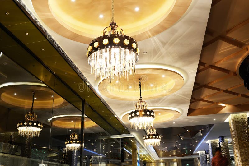 Luxury crystal chandelier lighting in hotel. Luxury chandelier lighting is lit up by led lamp bulbs in a hotel stock photos