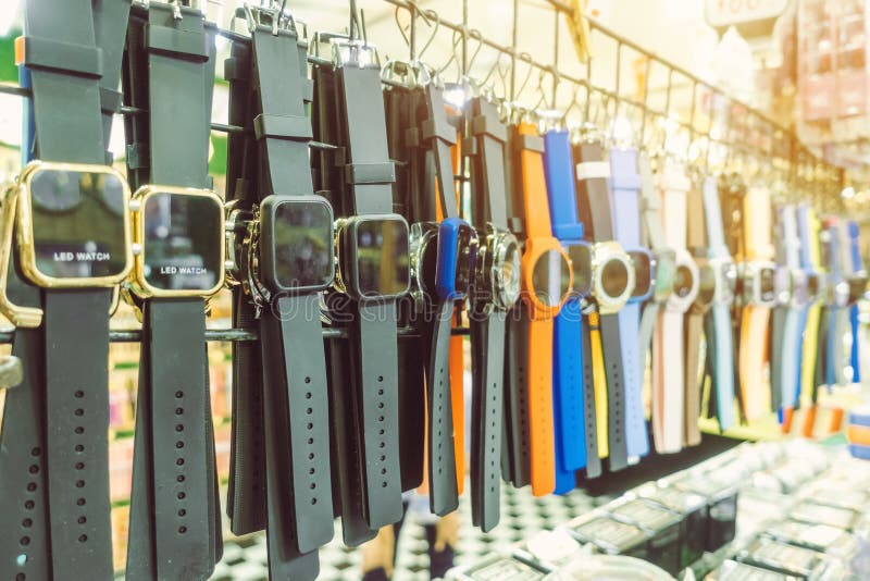 Many modern wrist watchs hang on to show and inexpensive for sale in local market. Selective focus stock image