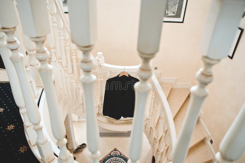 Men black suit luxurious steps railing inside cottage. Men black suit on the luxurious steps with a railing inside the cottage, elegant, successful, clothing royalty free stock images