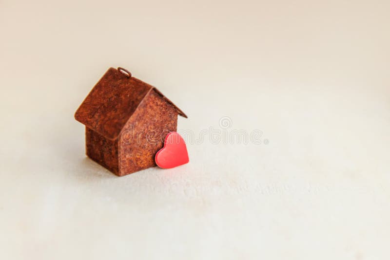 Miniature toy model house with red heart on wooden backdrop. Eco Village abstract environmental background. Real estate mortgage stock photos