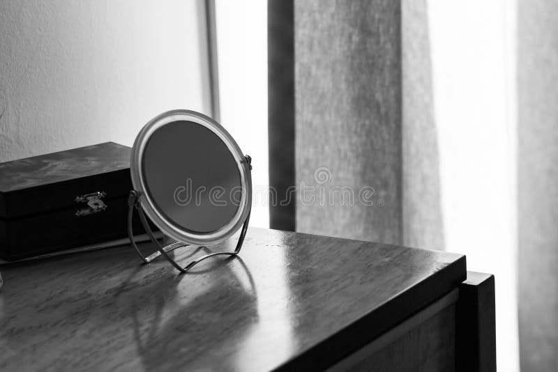 Mirror on Polished Wood Dresser in Bedroom royalty free stock images