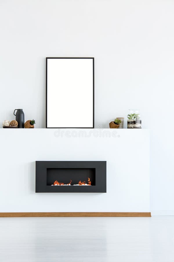 Mockup of empty poster above black fireplace in simple white living room interior. Real photo royalty free stock images
