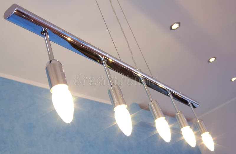 Modern chandelier. Modern stainless chrome chandelier with candle light bulbs in row royalty free stock images