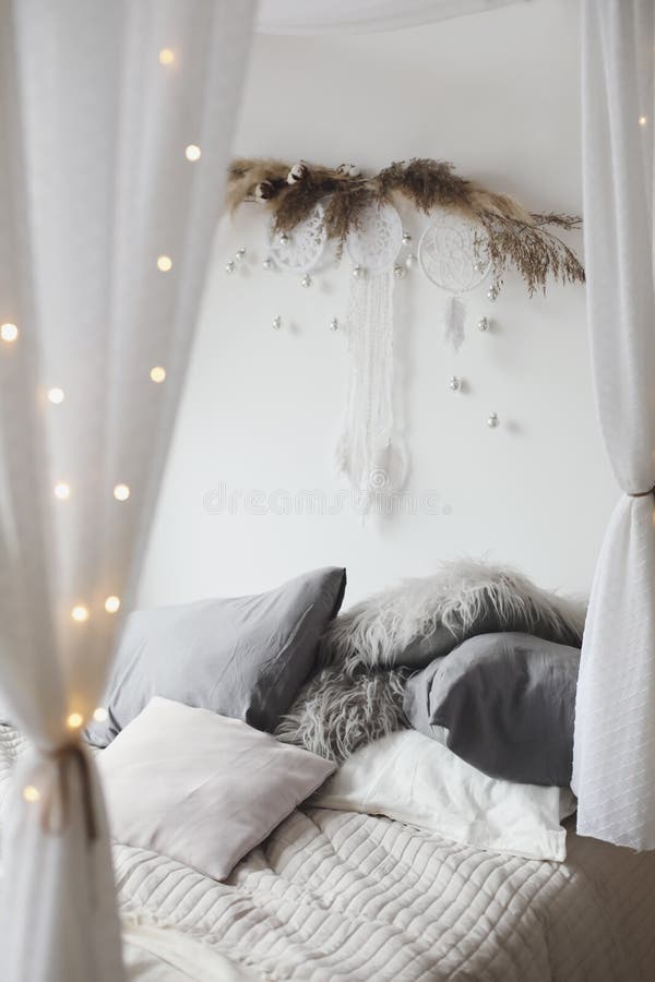 Modern home interior design. Cozy bed with wooden canopy and pillows, blanket. Bedroom interior, scandinavian style. stock image