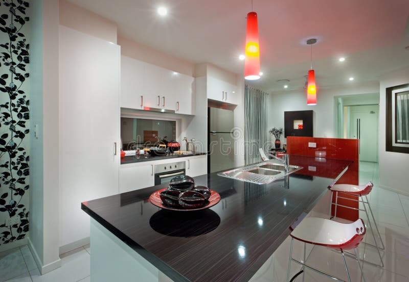 Modern mansion through the kitchen with red lamps stock photography