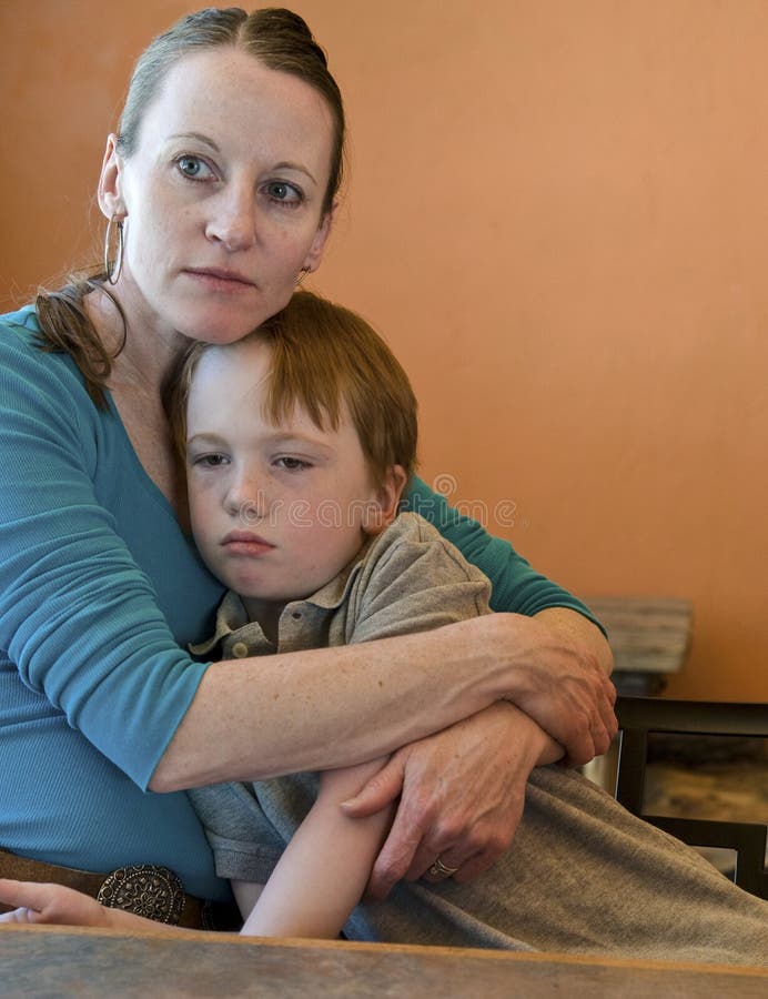 Mom hugging sad child. Mother hugs her crying/sad 6-year old son royalty free stock photos