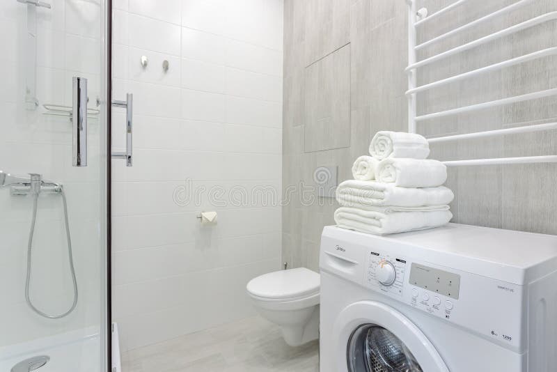 Bright bathroom with shower, toilet, washing machine and white towels 0074 royalty free stock photos