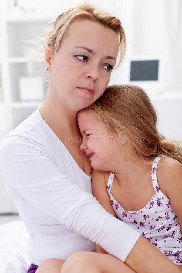 Mother comforting her child. Mother comforting her crying child royalty free stock image