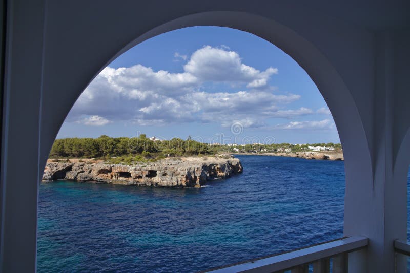 Ocean view from a balcony through a round arch royalty free stock images