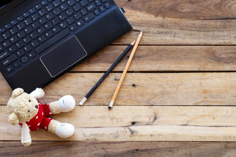 Office supplies computer notebook for business work with teddy bear  arrangement at office. On background wooden royalty free stock images