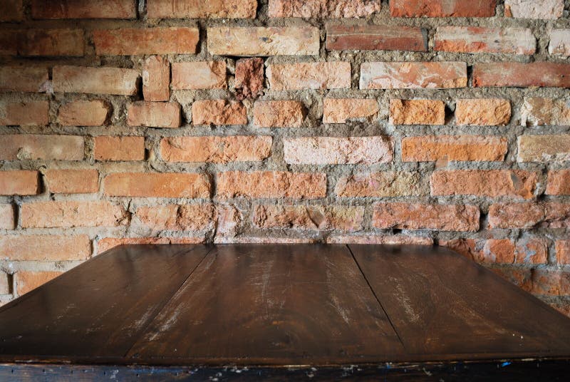 Old dirty interior with brick wall, vintage background. With wooden table stock photos