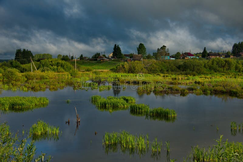 Picturesque cloud cover over the dacha village. Russia. Kemerovo region Kuzbass. Dacha village on the shore of a swampy lake near the city of Mariinsk royalty free stock images