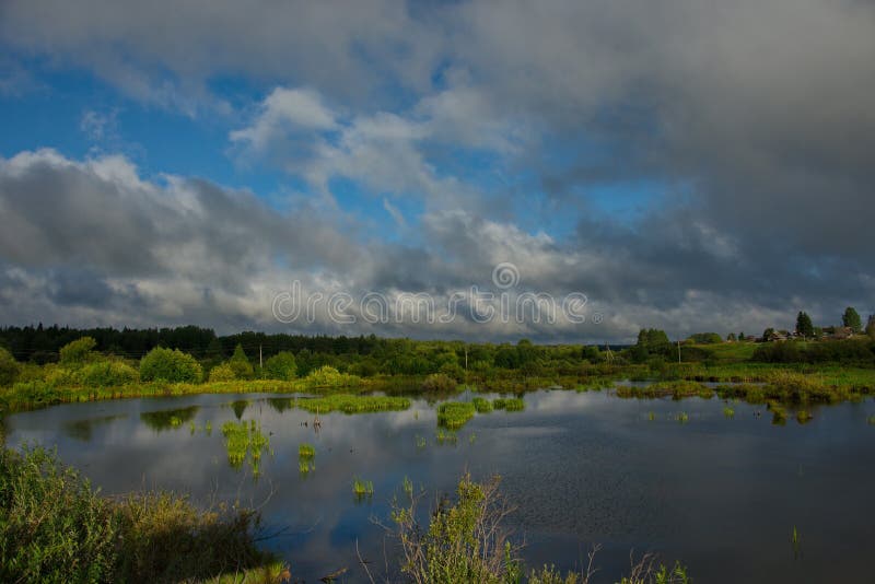 Picturesque cloud cover over the dacha village. Russia. Kemerovo region Kuzbass. Dacha village on the shore of a swampy lake near the city of Mariinsk stock photo