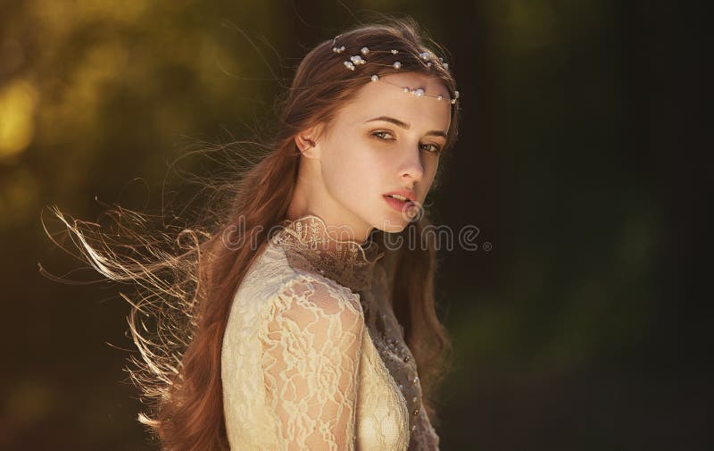 Portrait of a cute dreamy girl wearing retro blouse and skirt outdoors. Soft vintage toning. stock images