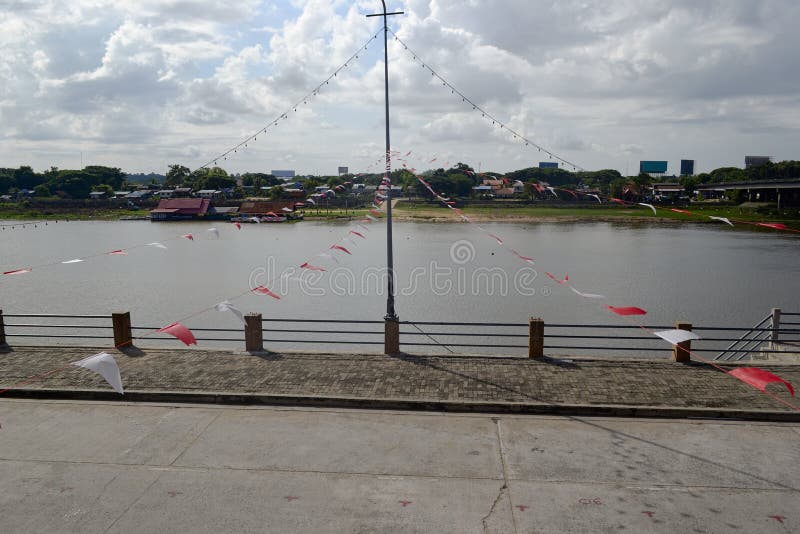 Red and white triangular flags on the riverside royalty free stock image