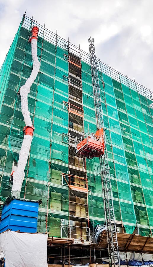 Renovations apartment building with scaffolding, Apartment building thermal insulation mineral wool slabs. Insulated apartment stock photos