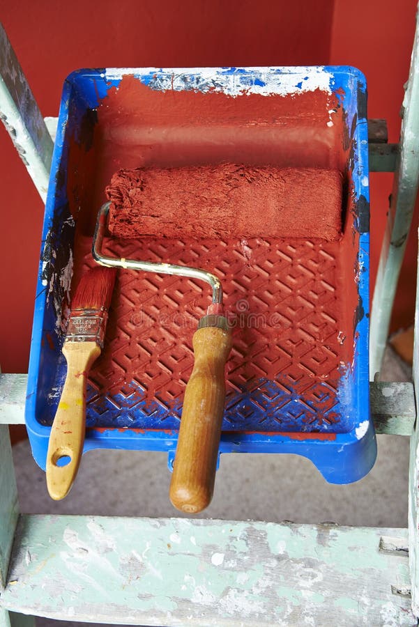 Renovations. Painting tools. Renovations. Painting with red wall royalty free stock photo