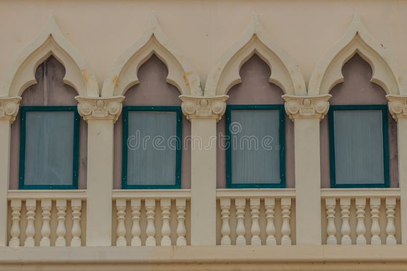 Row of arch windows on the balcony with stucco wall background. Row of arch windows on the balcony with stucco wall background of architecture stock photography