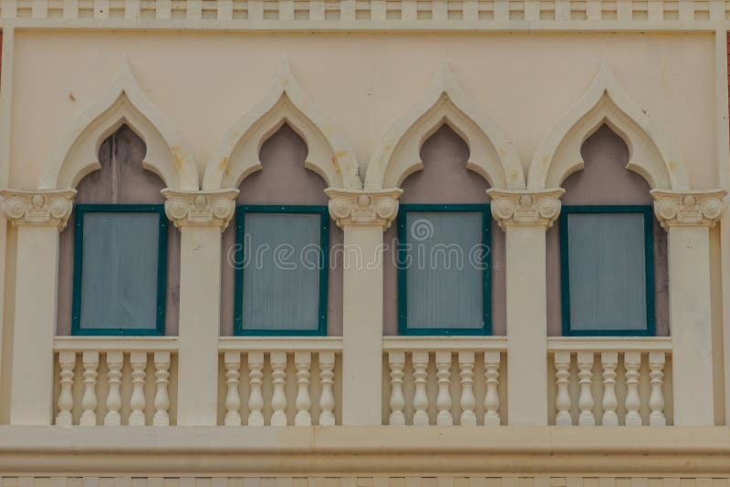 Row of arch windows on the balcony with stucco wall background. Row of arch windows on the balcony with stucco wall background of art royalty free stock images