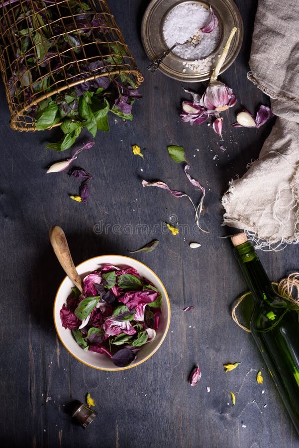 Salad with fresh summer greens and herbs on rustic wooden table. View from above, free text space. Fresh salad with fresh summer greens and herbs on rustic royalty free stock photo