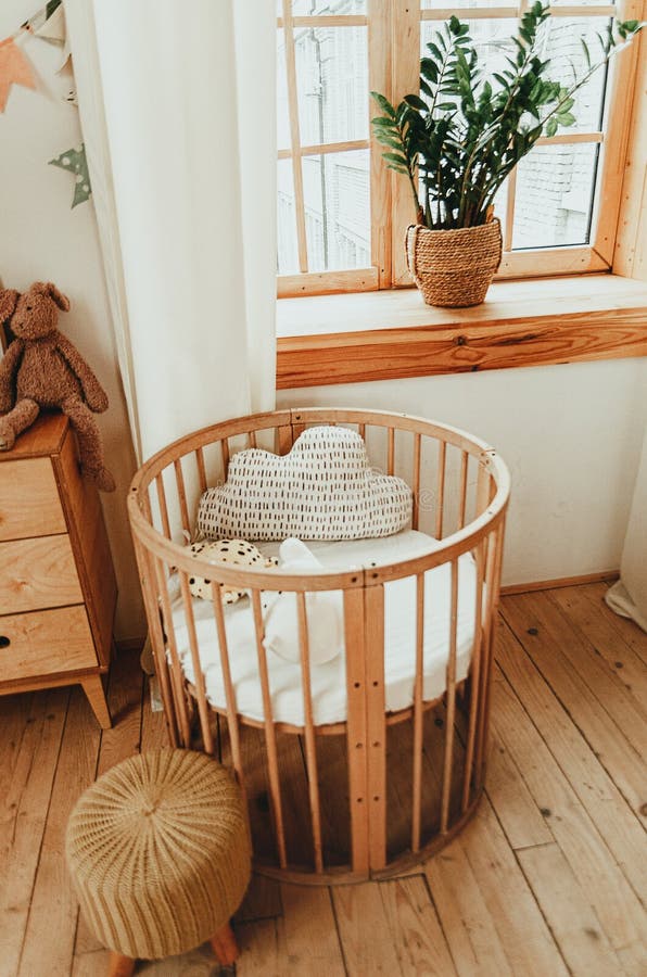 Scandinavian style children`s room interior. A cozy oval baby bed cradle. Home Sweet Home stock photography