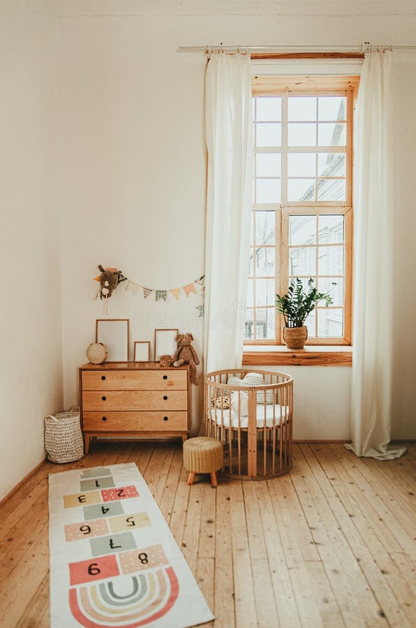 Scandinavian style children`s room interior. A cozy oval baby bed cradle. Home Sweet Home royalty free stock image